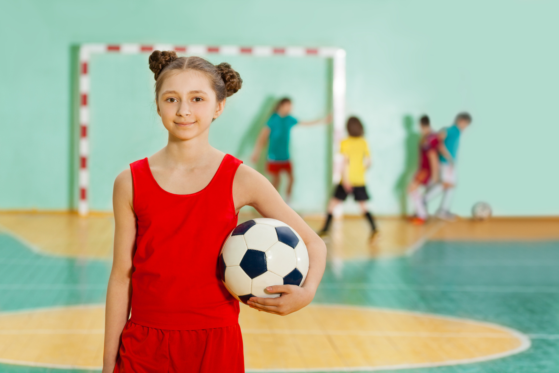 Girl Standing with Soccer Ball